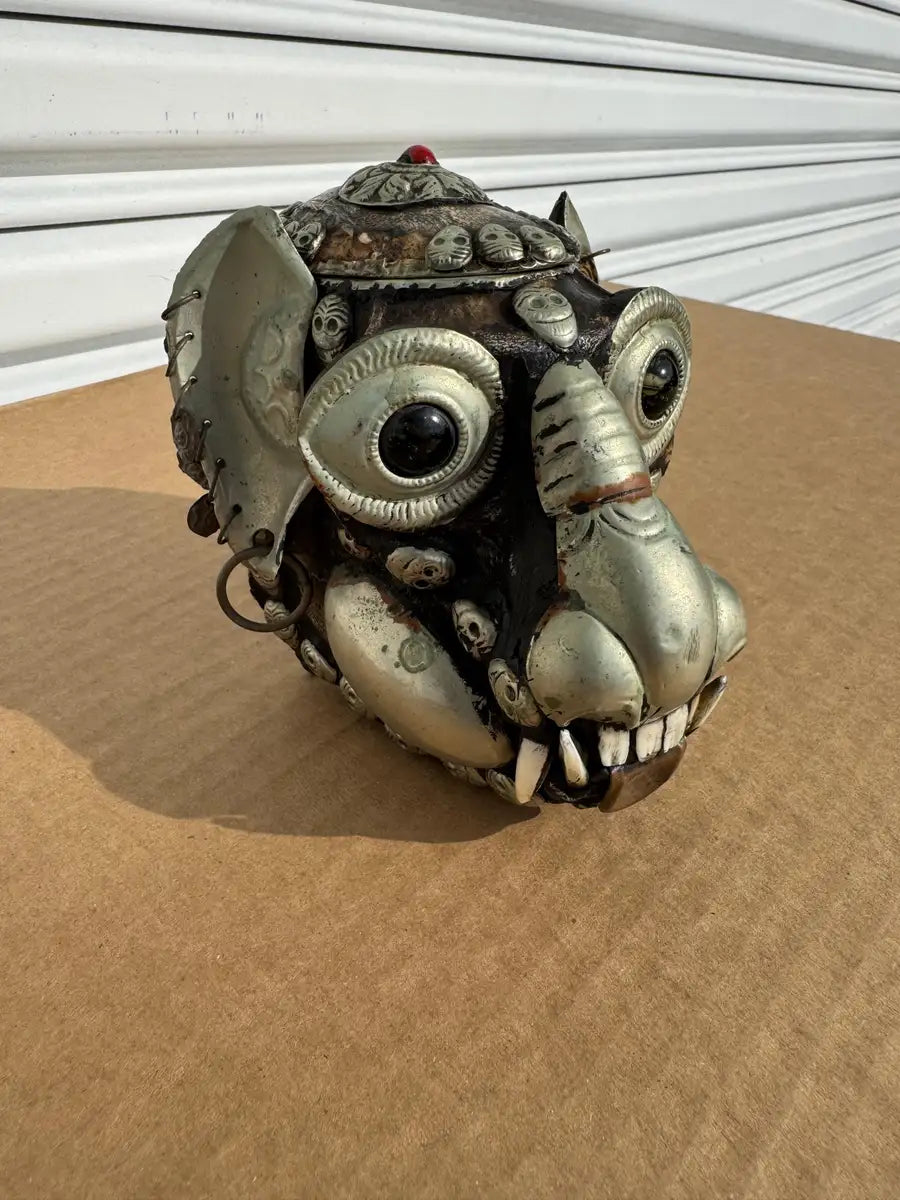 handcrafted monkey skull sculpture with metal detail