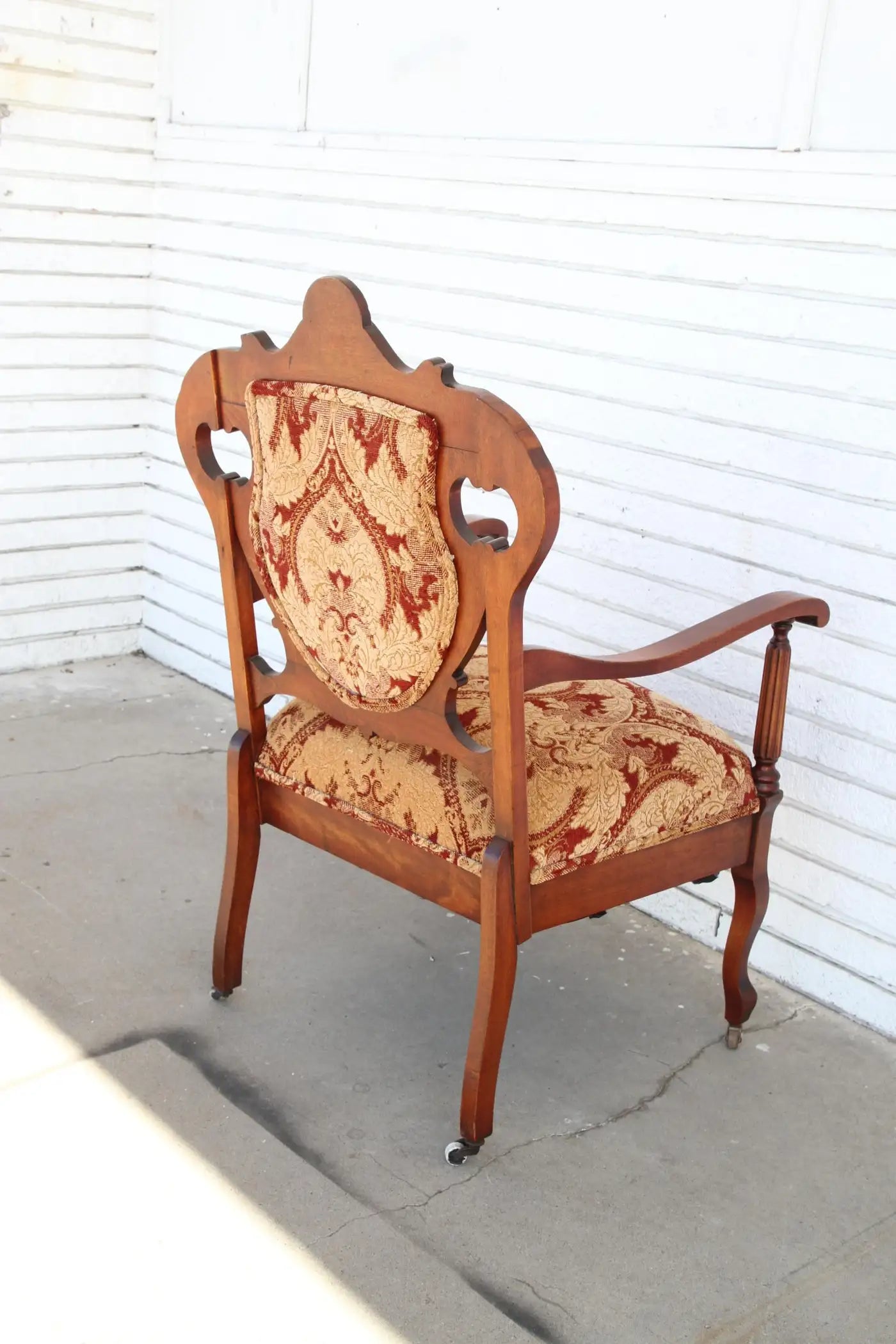 Antique Armchair with upholstery on casters