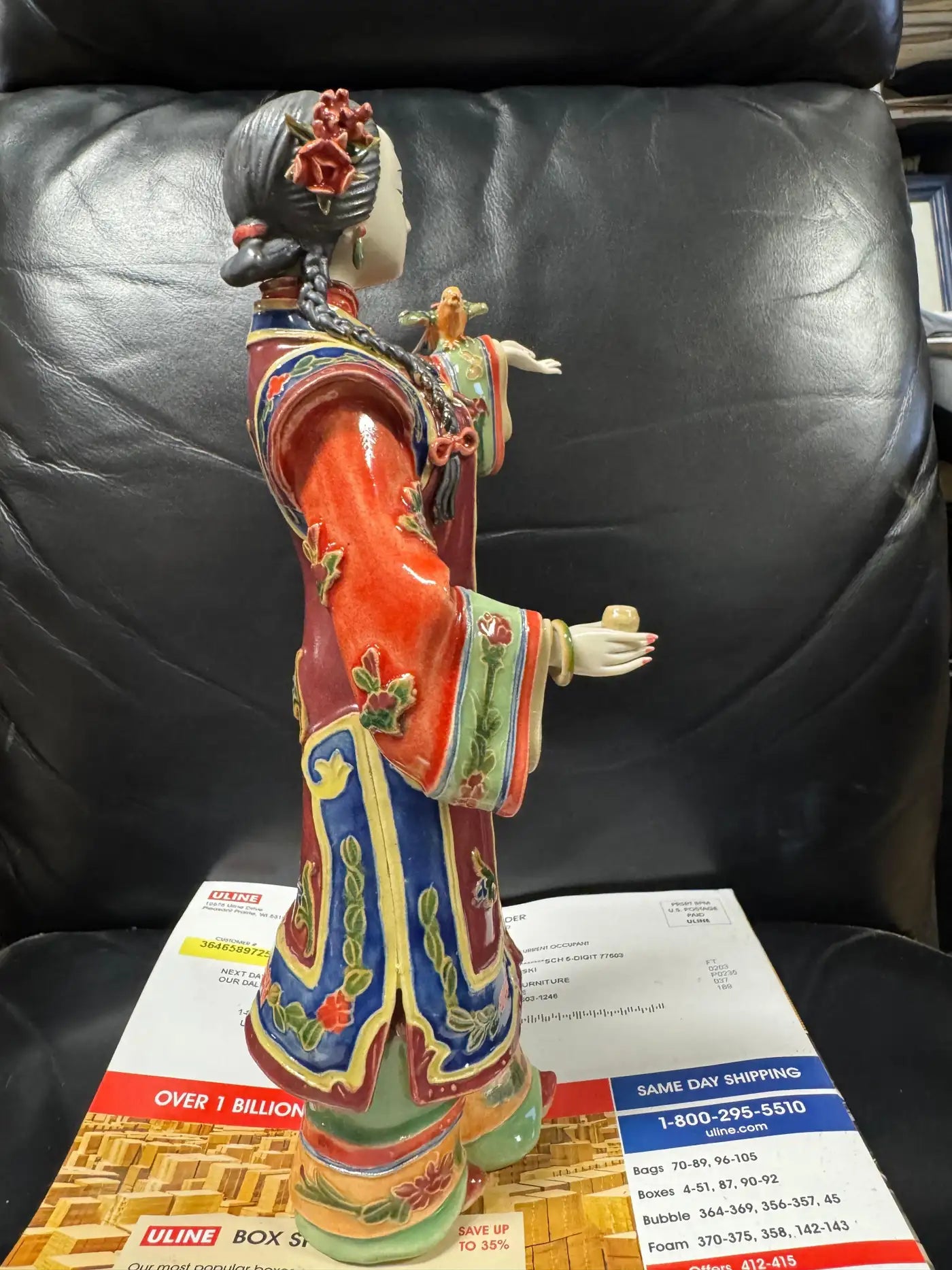 Colorful Asian porcelain figurine with floral enamel patterns