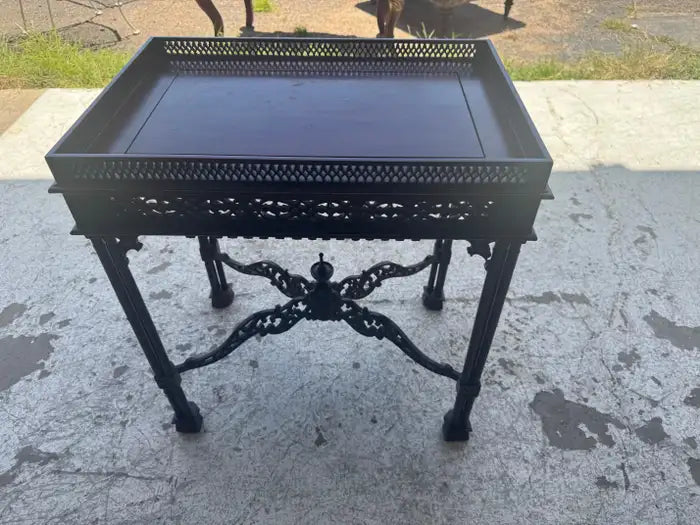 Mahogany accent table with ornate carved wood detailing