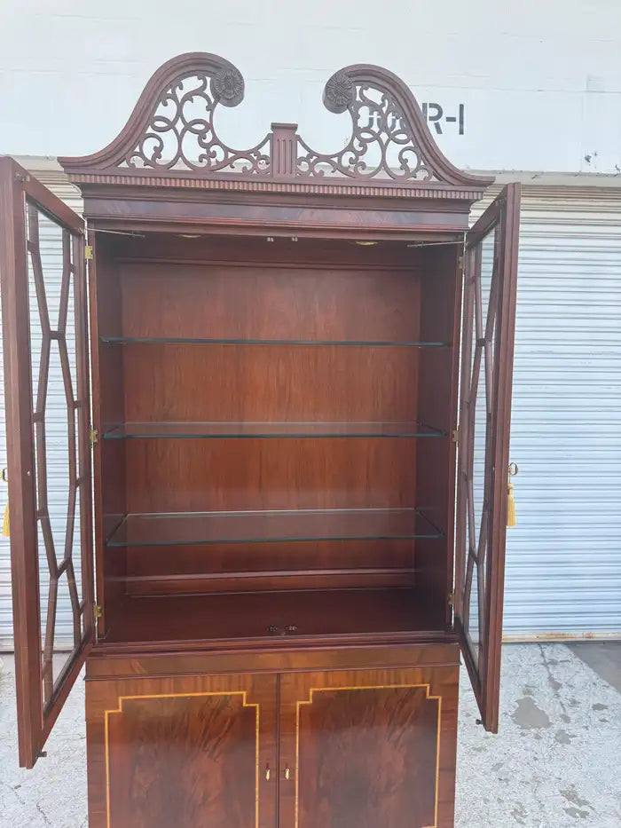Vintage mahogany china cabinet with illuminated interior shelves