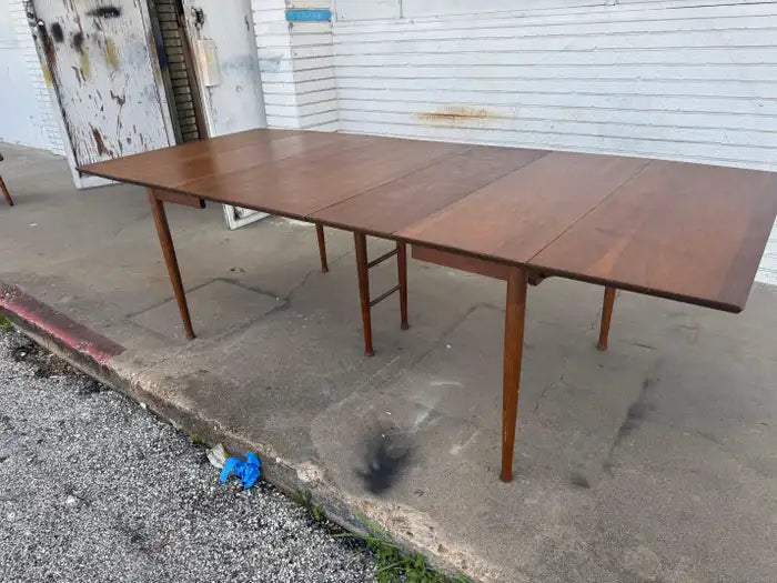 Expandable dining room table in rich walnut finish