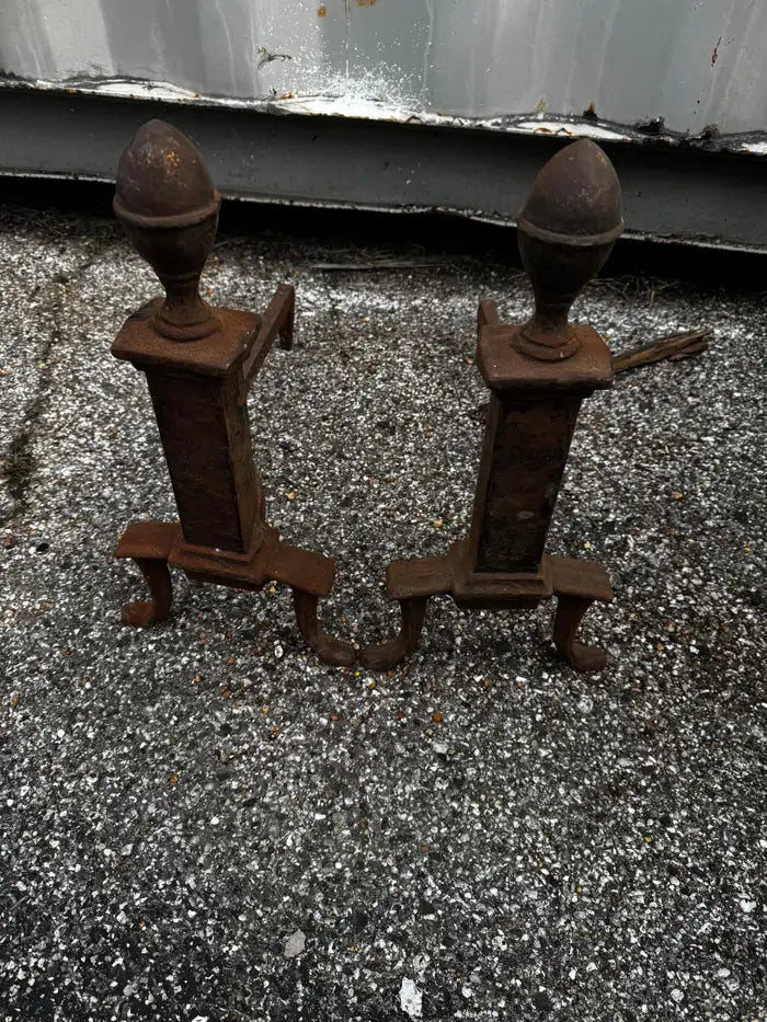 Vintage black wrought iron andirons with detailed acorn tops