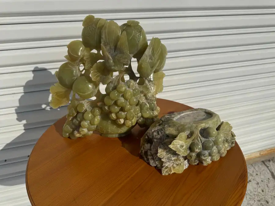 Vintage jade figurine with birds perched on grape cluster