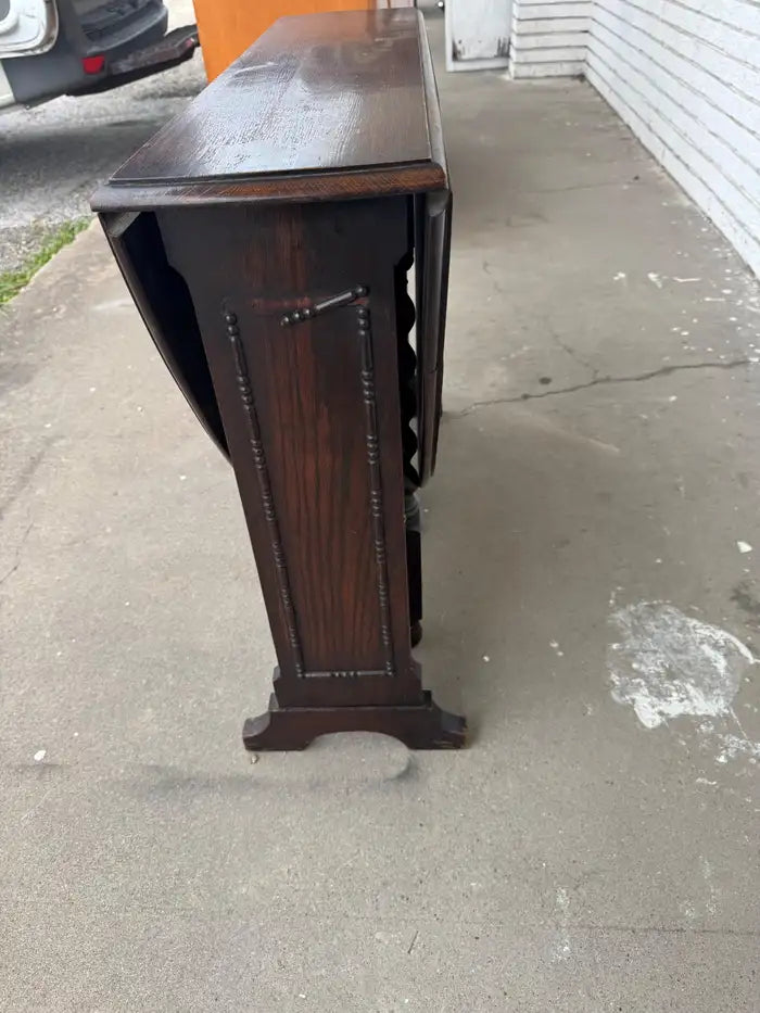 Space saving walnut dining table with drop leaves