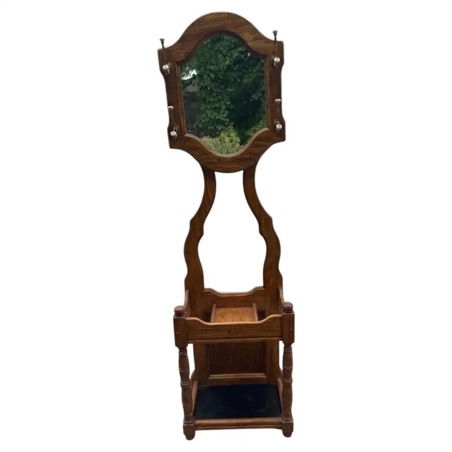 Vintage oak entryway hall tree with carved wood craftsmanship