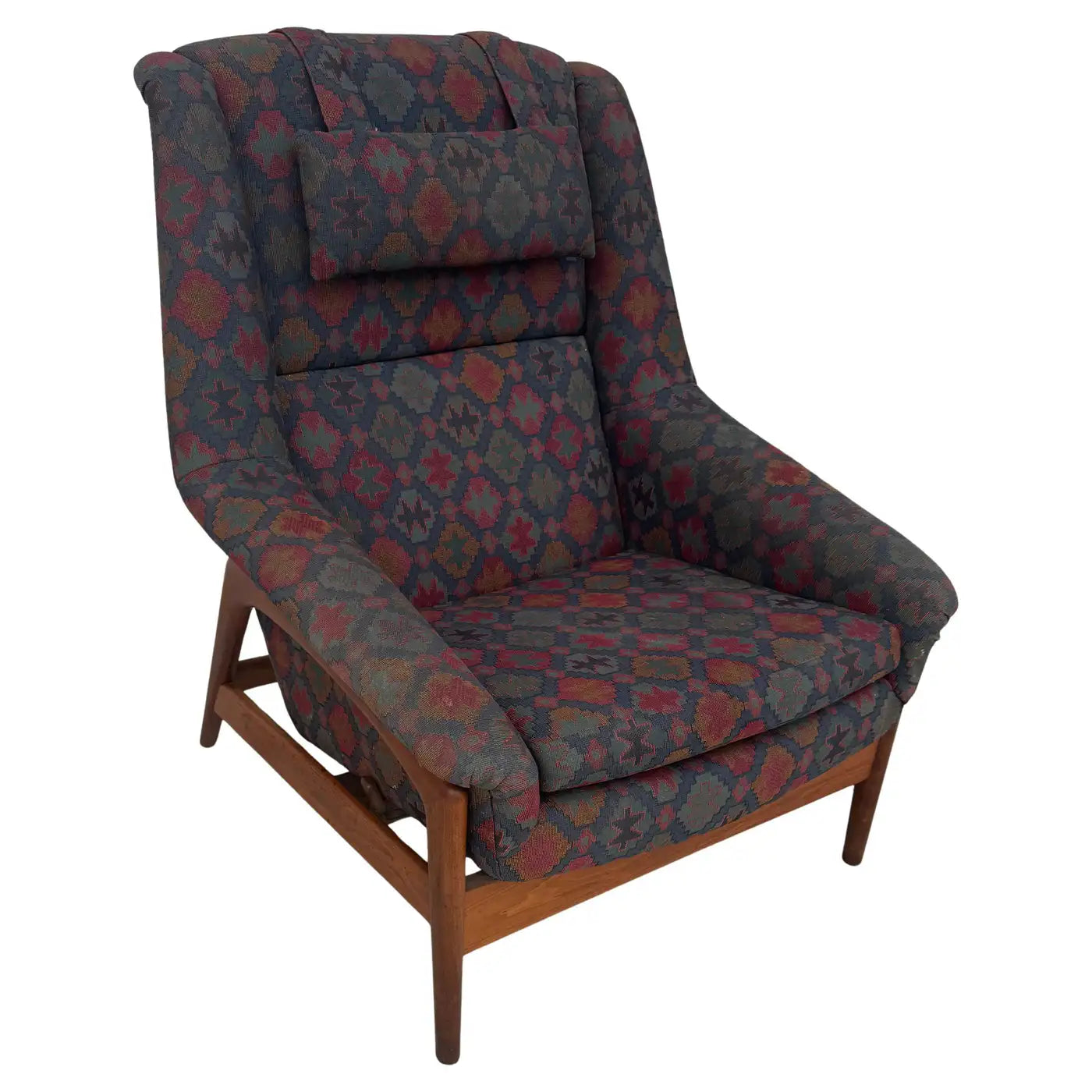 Side view of Swedish modern DUX recliner with high back, arm cushions, and geometric fabric for cozy reading corner seating.​
