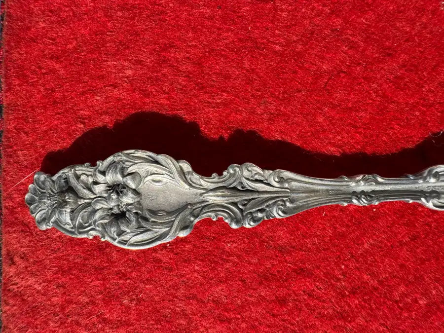 vintage sterling silver utensil with intricate handle pattern