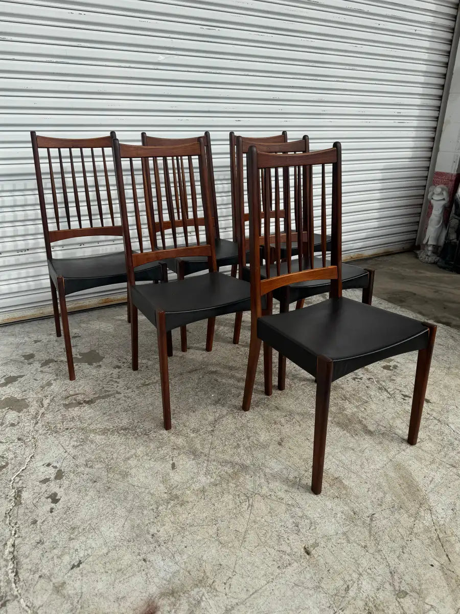 Danish modern teak chairs with curved backrests and clean lines