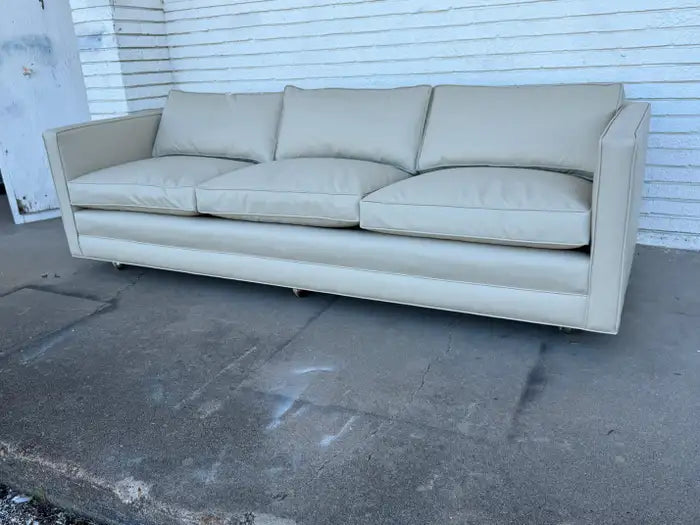 Reupholstered Dunbar style three seat sofa