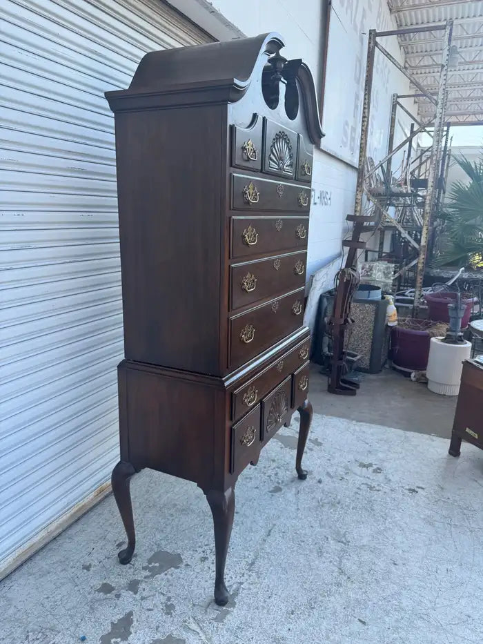 Vintage walnut highboy dresser with classic wood craftsmanship