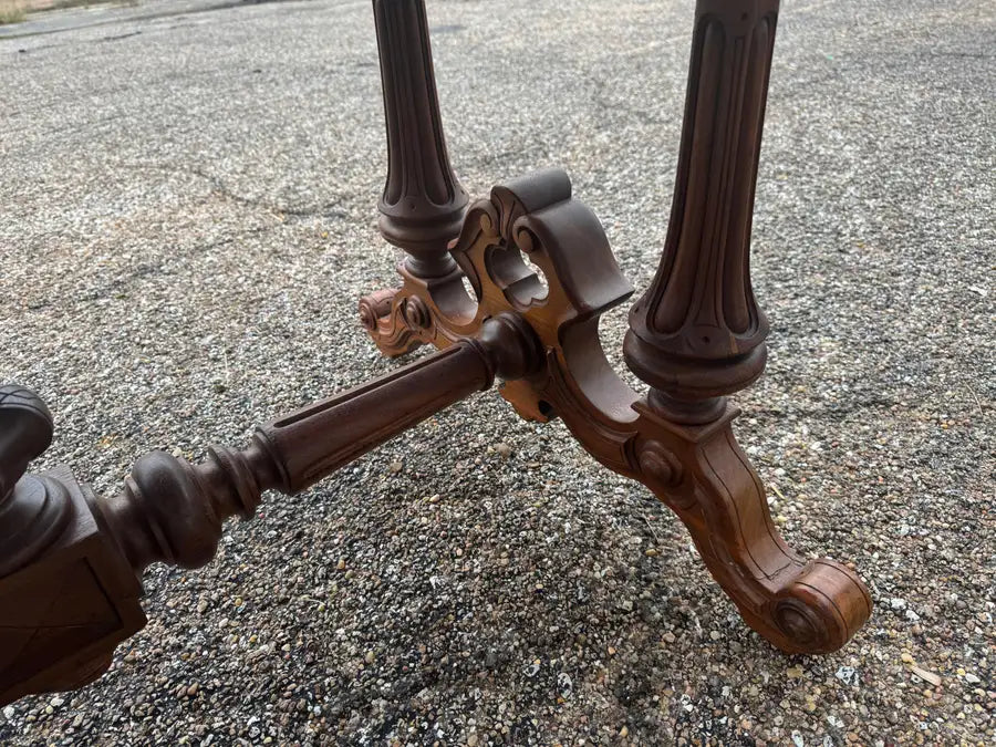 Antique office desk with carved legs and maroon leather top