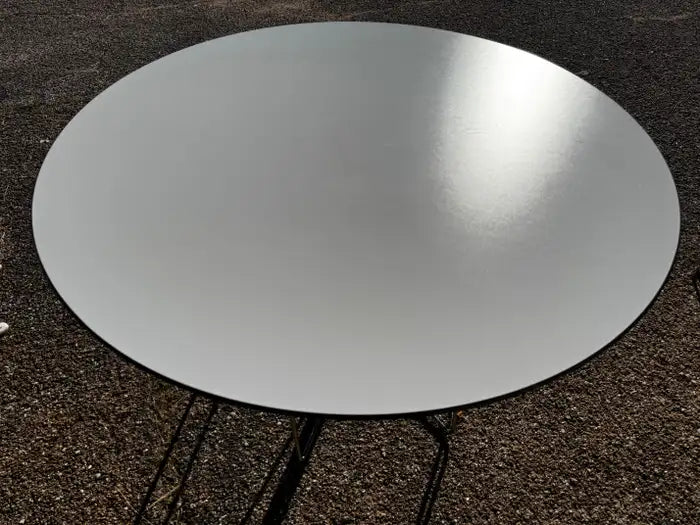 White laminate top round table with clean modern design
