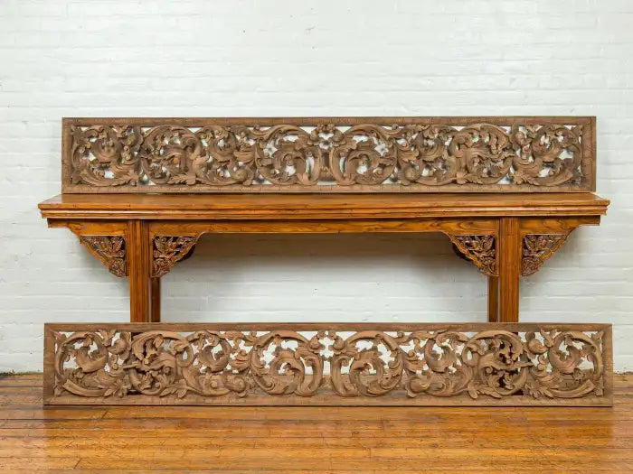 Hand-carved wooden temple panel featuring Indonesian scrollwork.