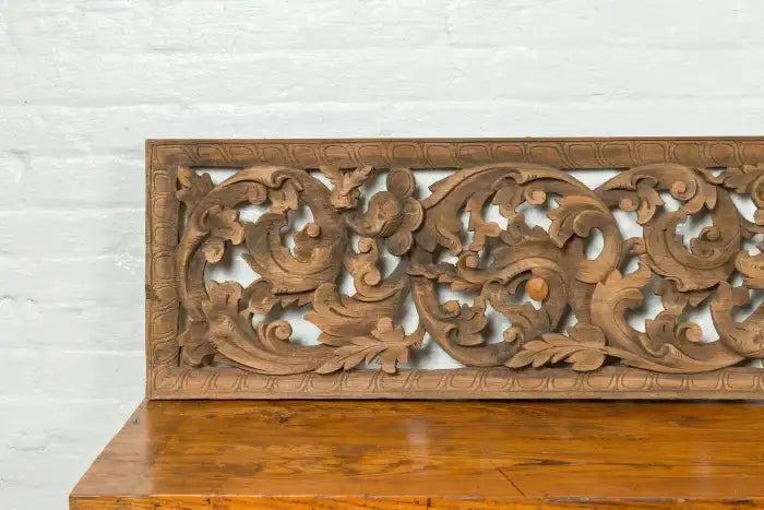 20" x 60" Indonesian wood wall art with foliage carving.