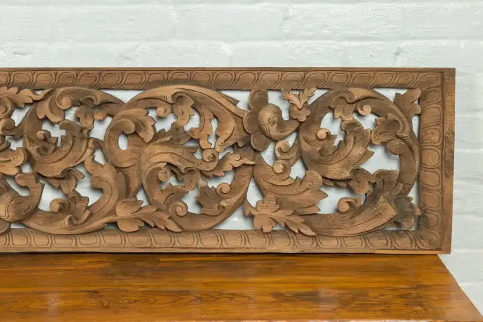 Exotic Indonesian temple panel with intricate carved foliage.