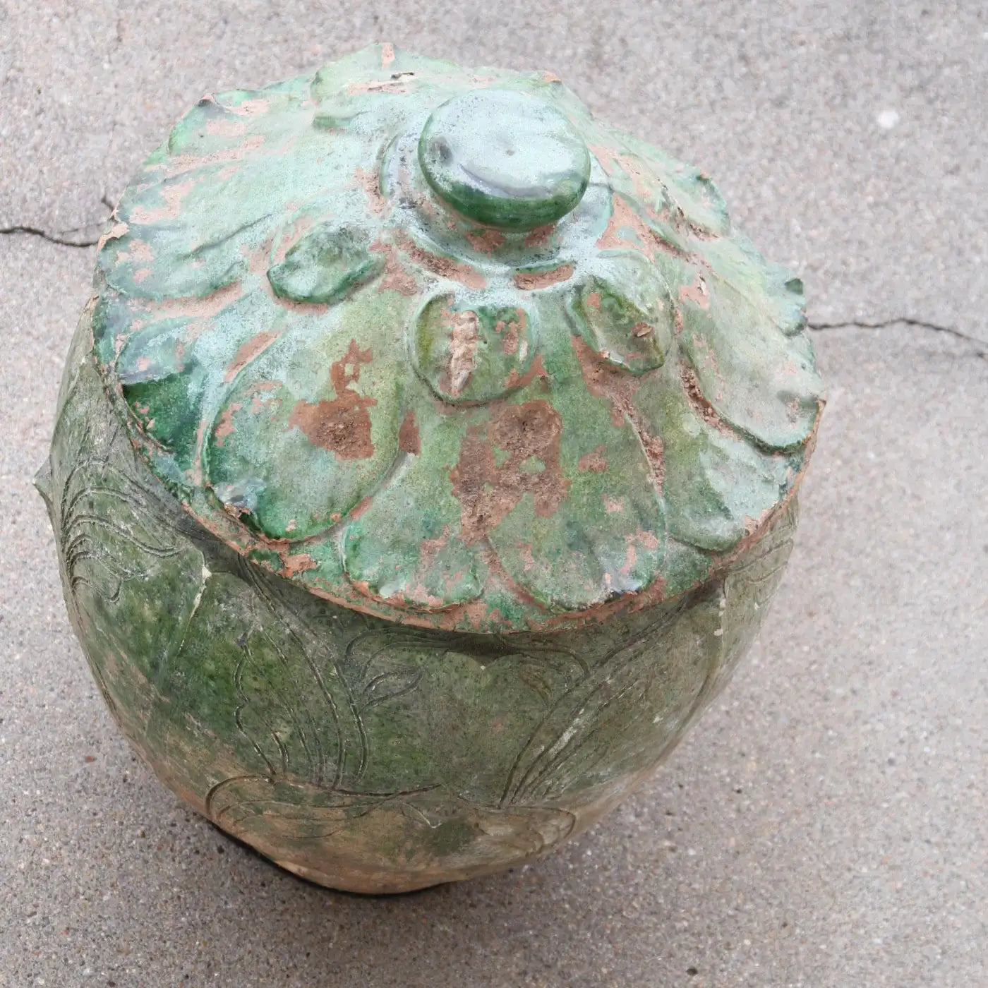 Ancient Chinese ceramic pot with ornate lid