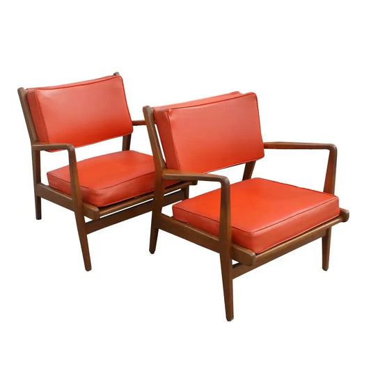Elegant Jens Risom walnut lounge chairs in a classic design