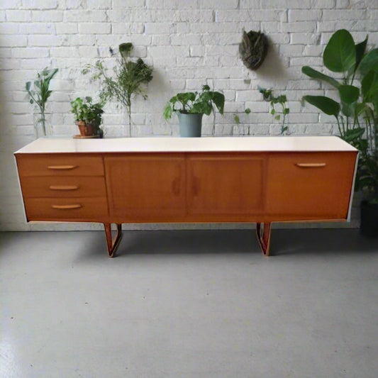 Mid century side board with sleigh base and folded handles