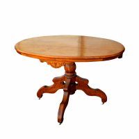 Antique Eastlake oval oak table with detailed wood carving