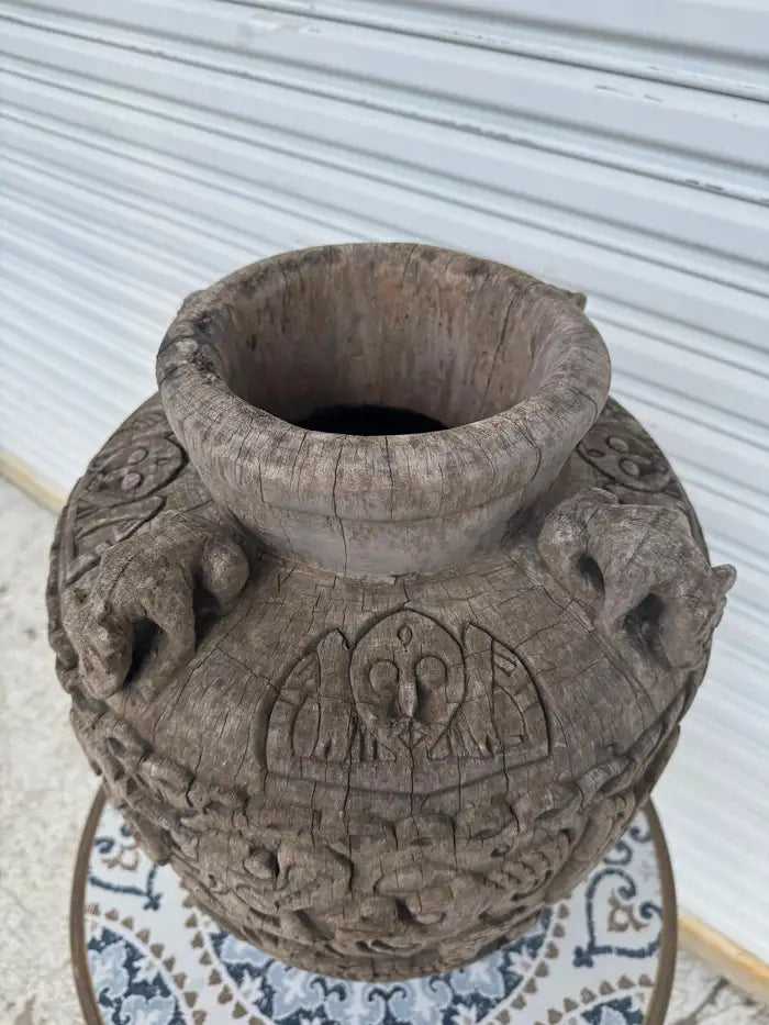 large antique wood vessel with intricate carved detail