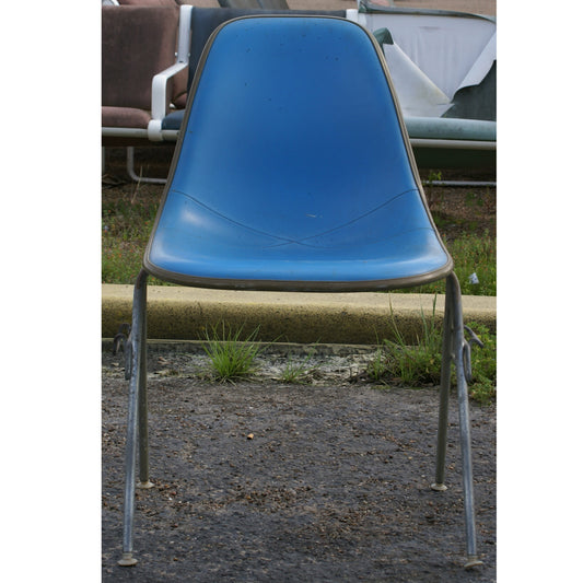 Blue mid-century modern elegance with the Herman Miller Eames Upholstered Fiberglass Shell Chair. Featuring a molded fiberglass shell and luxurious upholstery options, this chair offers both aesthetic appeal and ergonomic support.