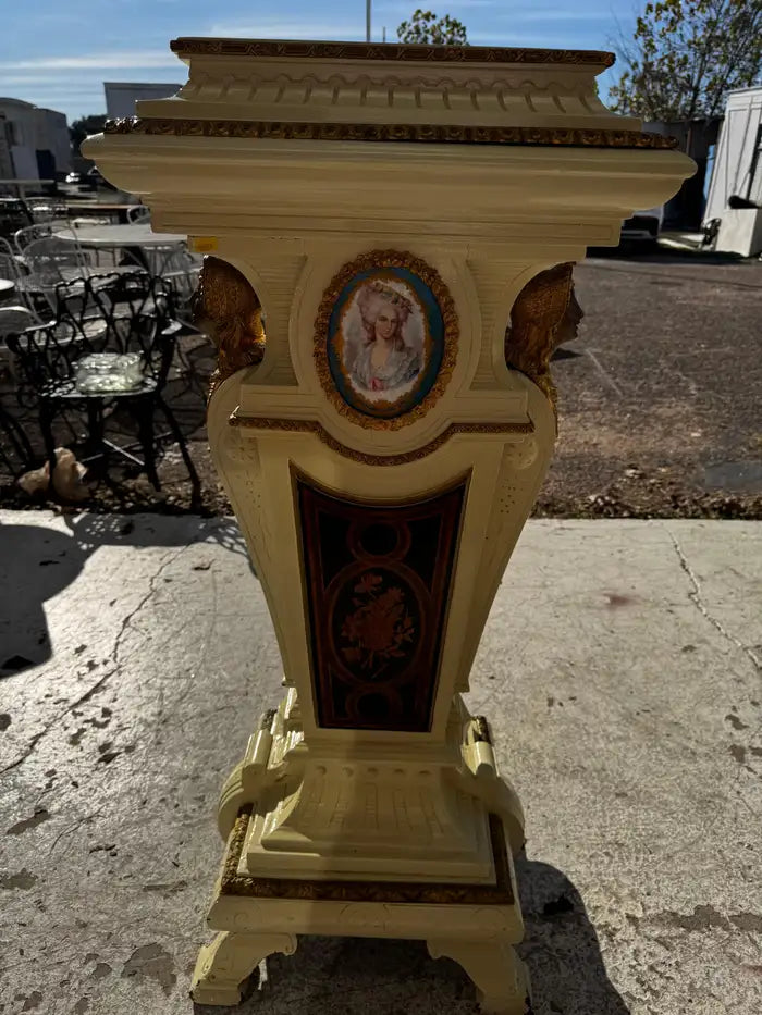 decorative pedestal with intricate carvings and gold ormolu detail