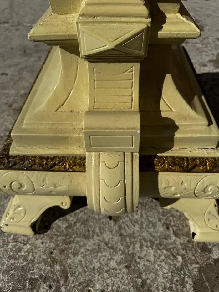 carved wood pedestal with intricate detailing and gold finish