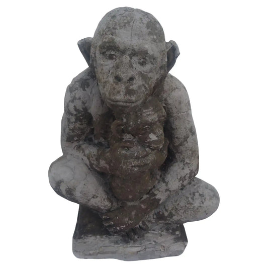 Cement cast monkey sculpture carrying child