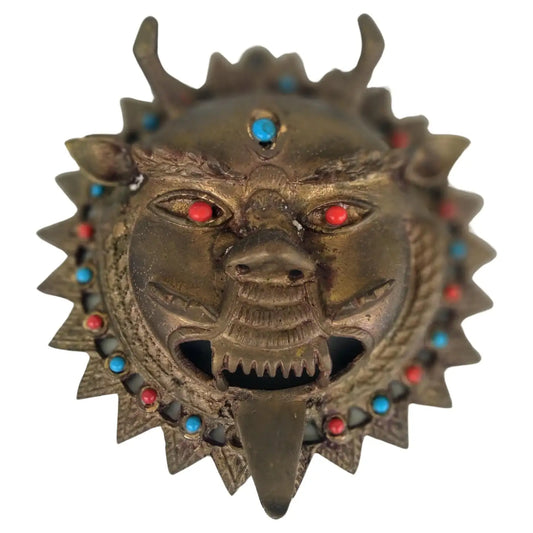Brass bejeweled mask from India with intricate detailing
