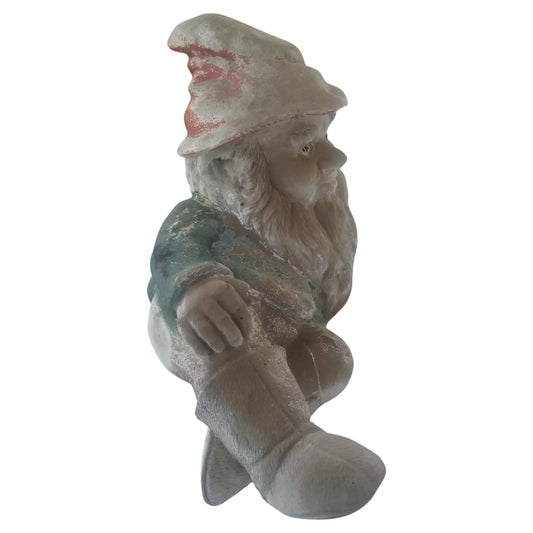 Vintage cement garden gnome lying down