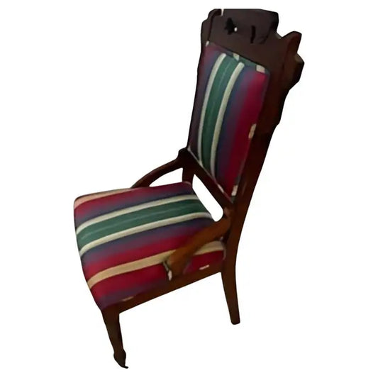 Antique Eastlake chair with casters on front legs – vintage design.