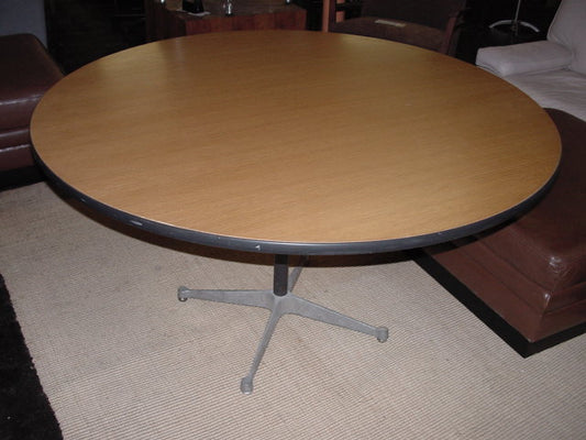 Eames 48" Round Oak Veneer Table from Herman Miller. Its minimalist style and sturdy construction make it ideal for dining, meetings, or collaborative workspaces.