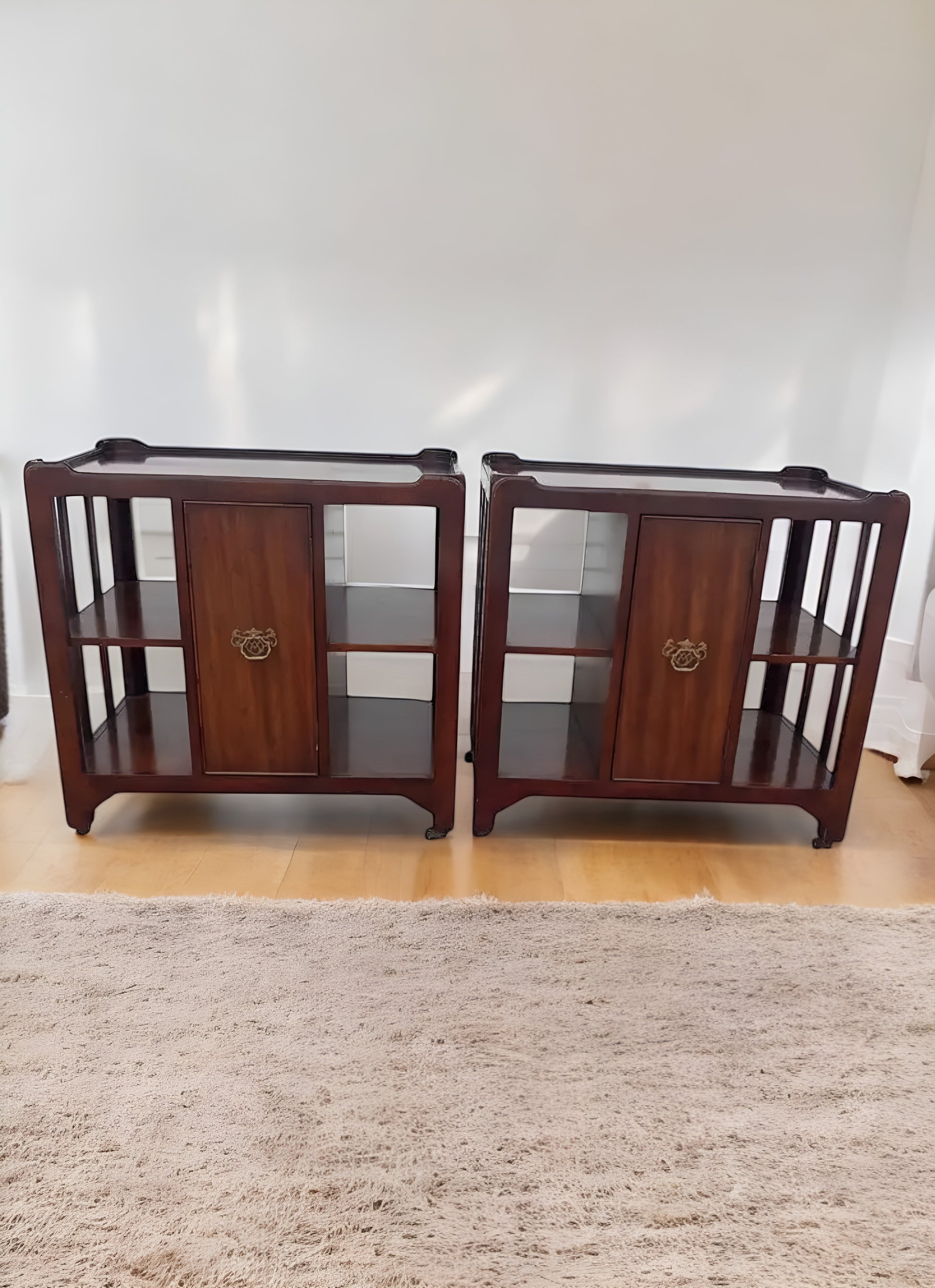 Vintage mahogany rolling side cabinets from the 20th century, perfect for mid-century decor.