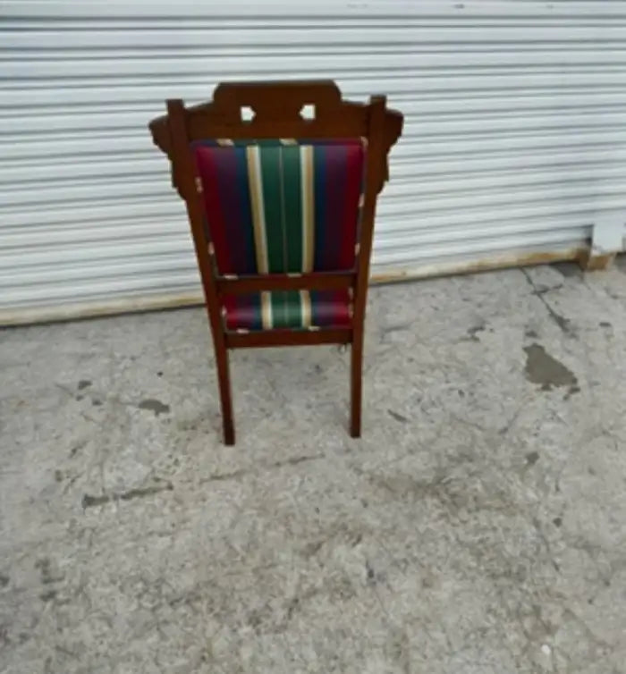 Antique Eastlake chair with casters on front legs