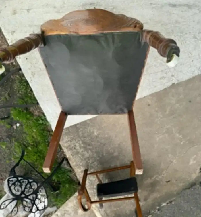 Antique Eastlake chair with casters on front legs