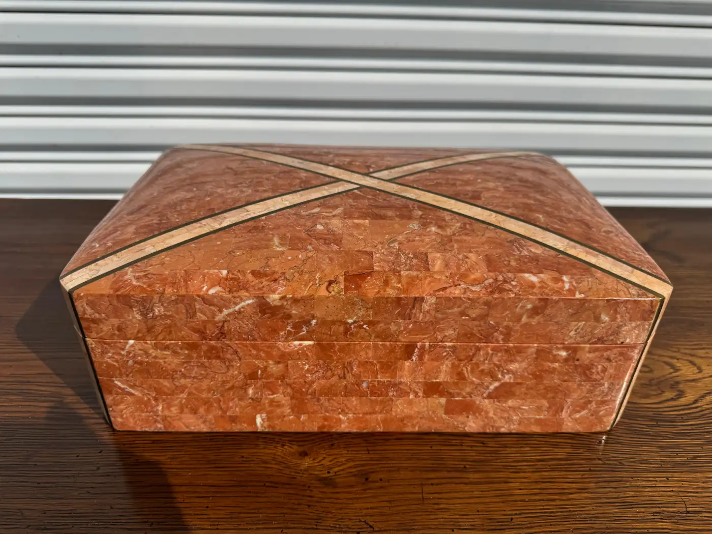 Premium coral-colored marble jewelry box with intersecting brass accents