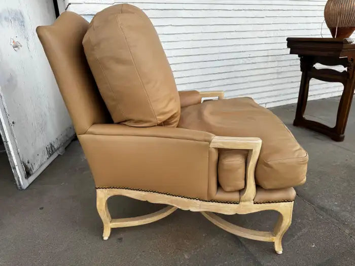 French bergere chair with exposed wood frame and leather seat