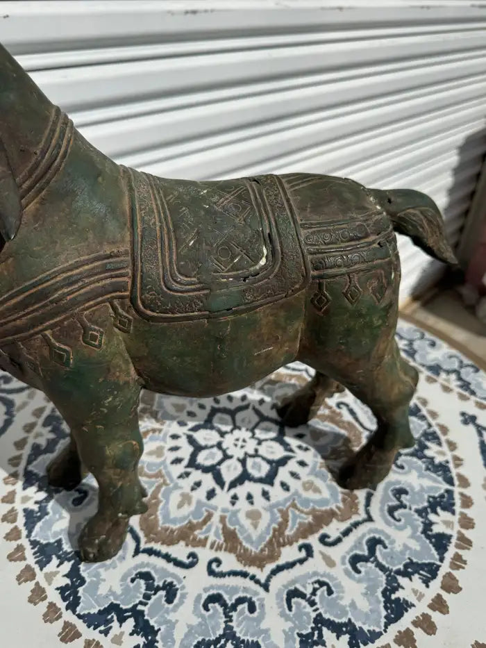 vintage metal goat sculpture textured surface detail