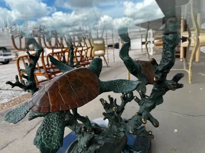 sculptural coffee table with bronze turtles and glass top